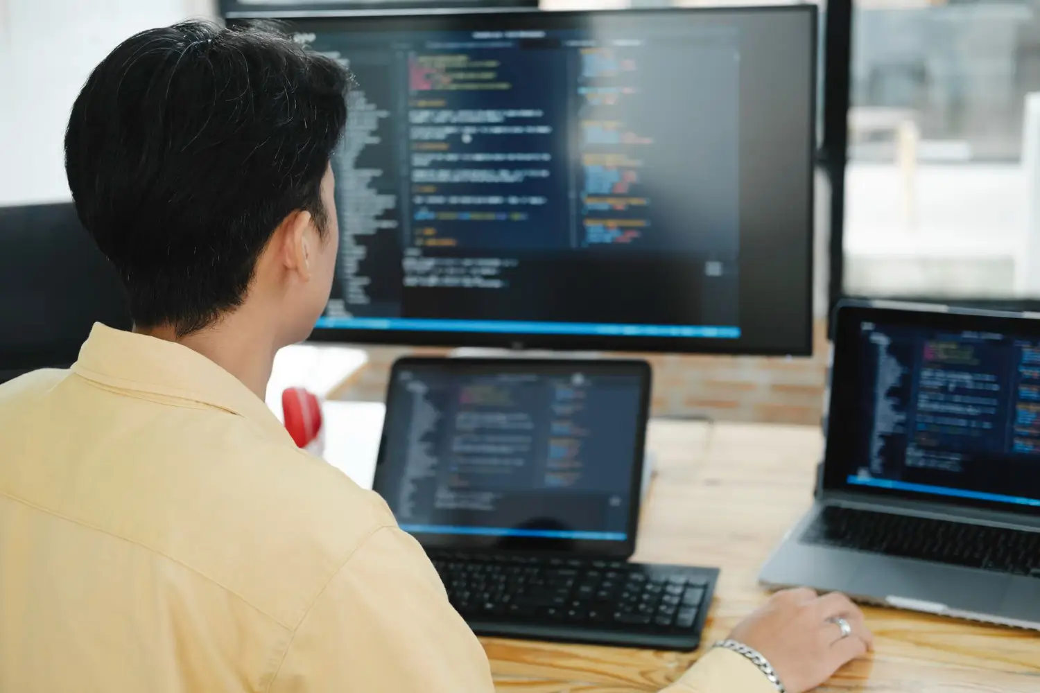 Full stack web development with frontend and backend code displayed across multiple screens