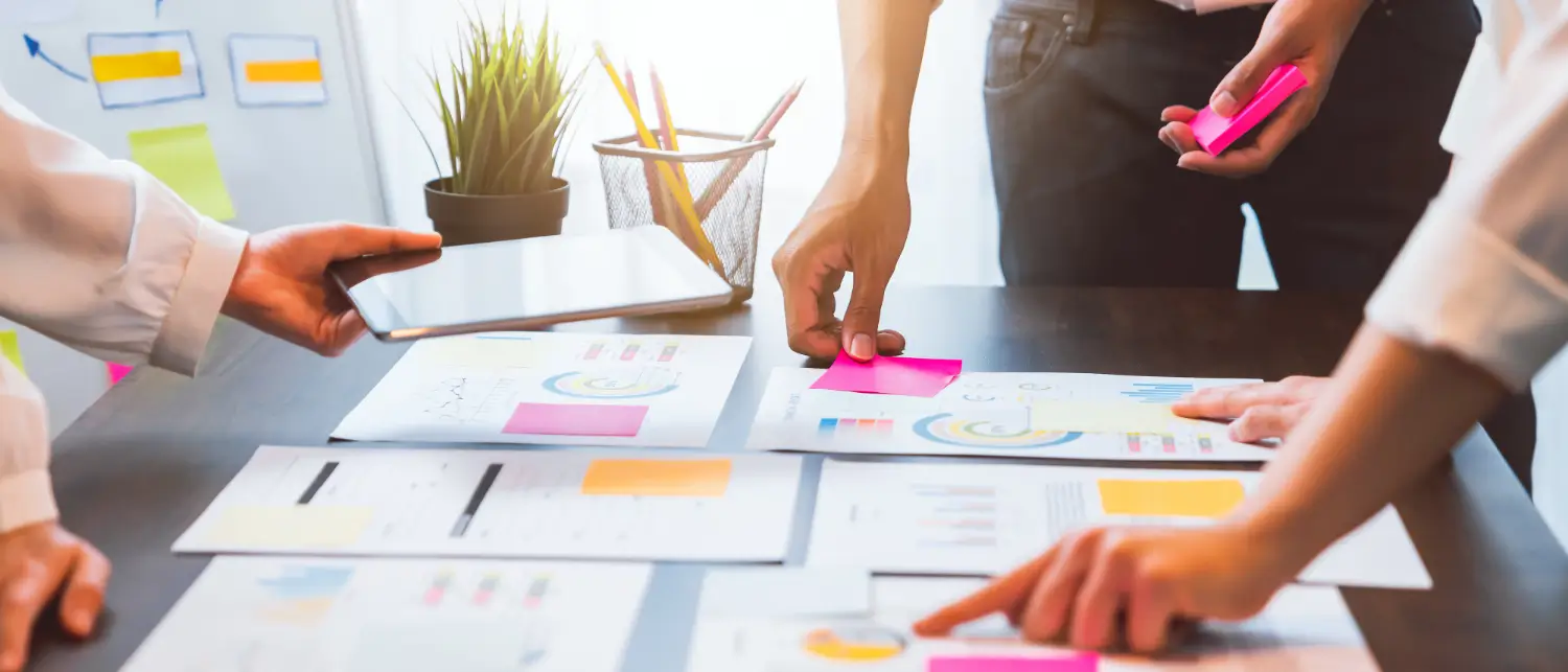 Marketing growth planning session with analytics and strategy documents