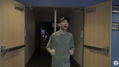 people standing in a circle with hands raised