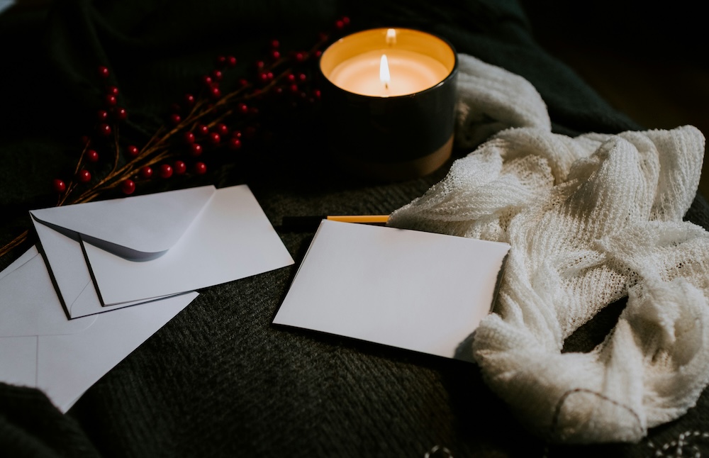 Blank white stationary and a small candle