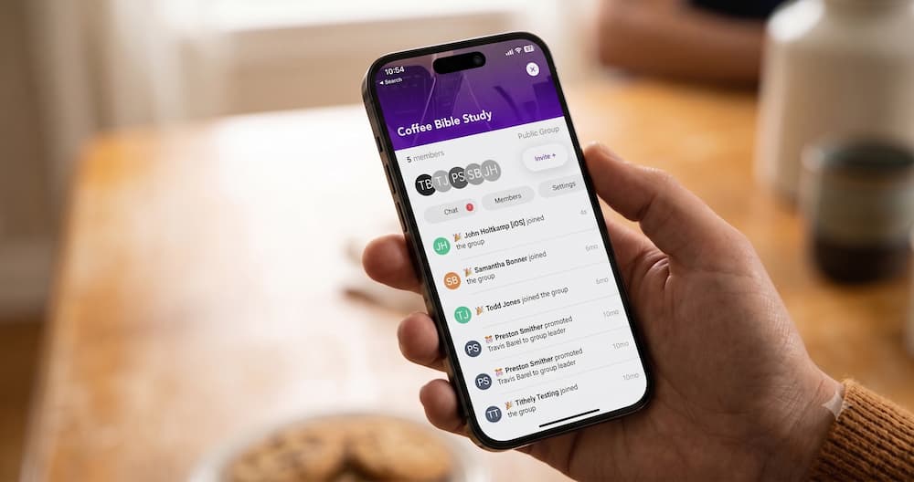 Person checking their Tithely church app's group messaging screen on a smartphone