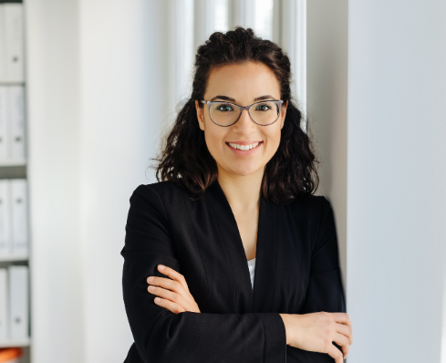 Woman standing with arms crossed smiling