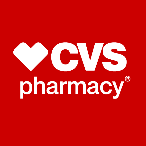 Interior of a CVS Pharmacy store with shelves of health products and a large red CVS Pharmacy sign above the prescription counter.