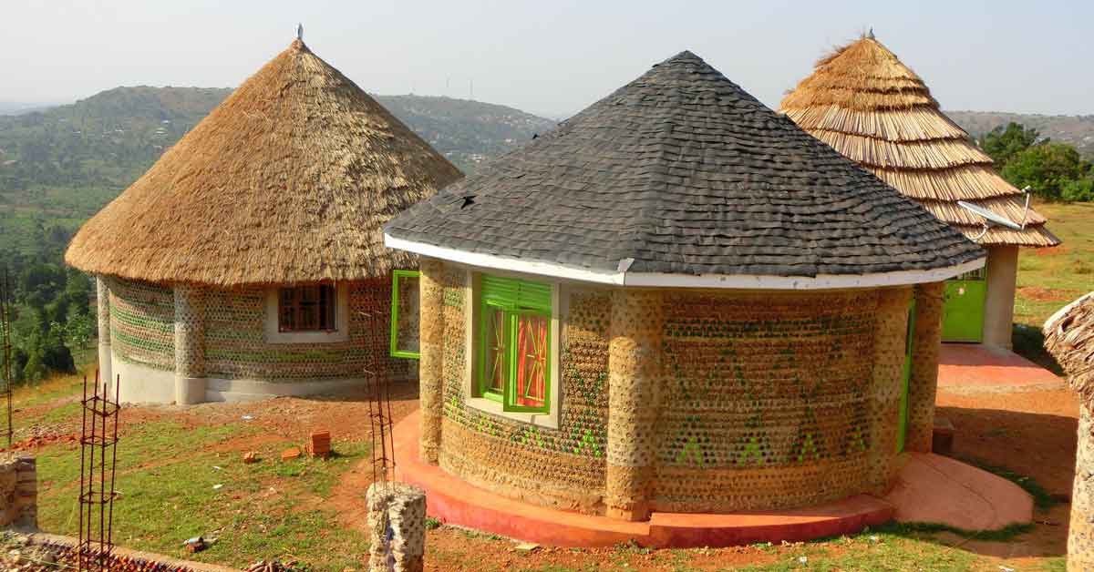 Three circular huts in Uganda made of plastic water bottles