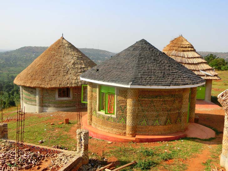Three circular huts in Uganda made of plastic water bottles