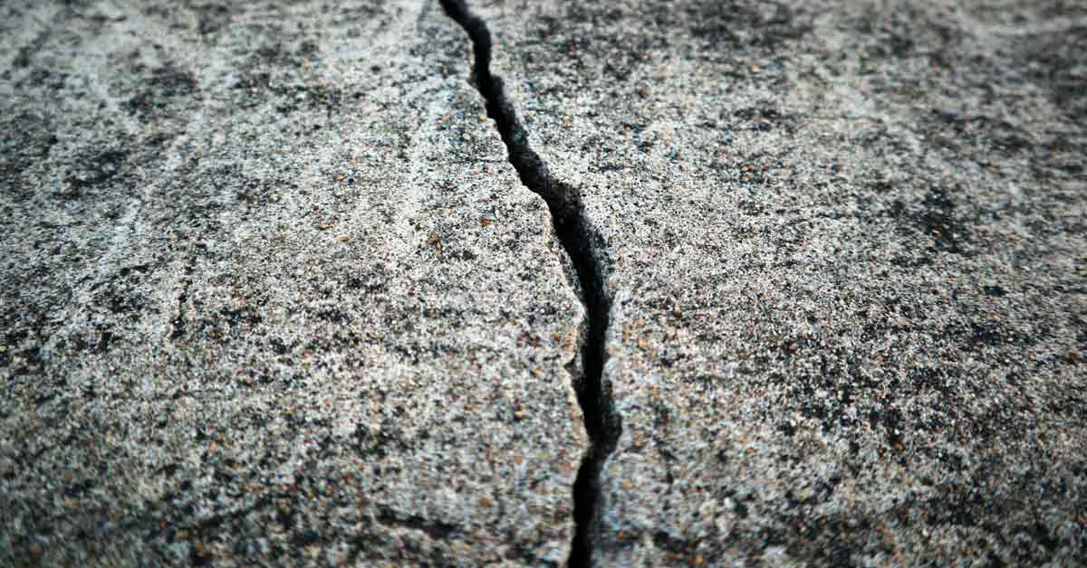 A crack splits two pieces of concrete in half