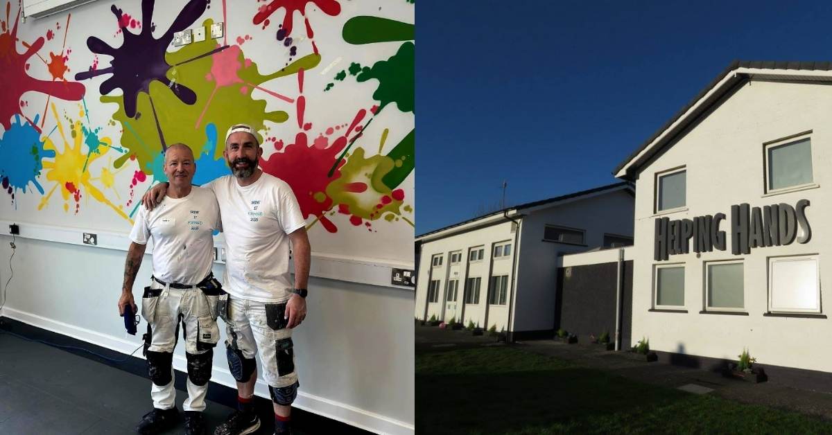 On the left: Gerard Donaghy, a white Irish man, smiles as he puts his hands around another white Irish man who volunteered to help paint. The wall behind them is full of bright splashes of color. On the right, the Autism Centre for Helping Hands