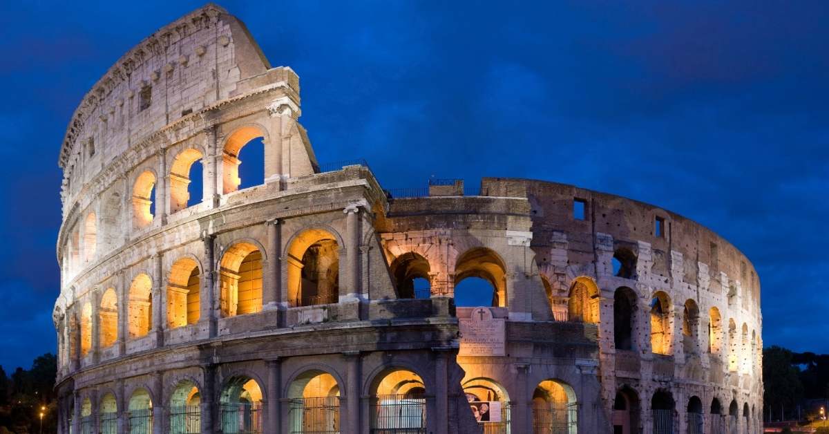 The Roman Colosseum lit up at nighttime. 