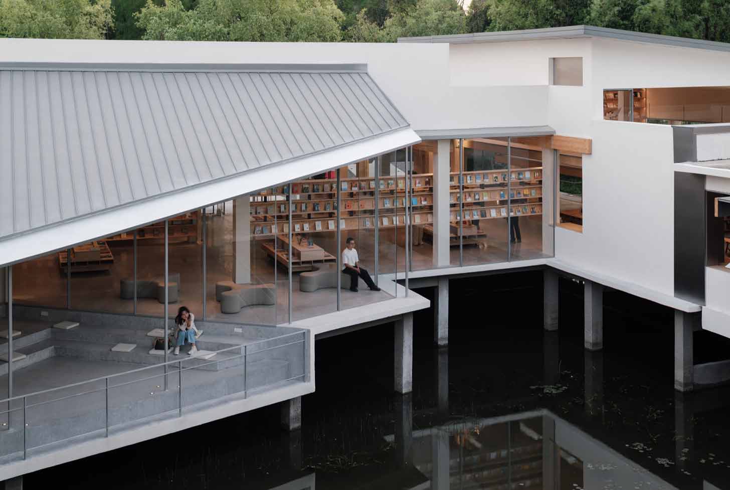 The Xixi Goldmye Bookstore in China sits atop the Xixi Wetlands, floating on pillars above the water