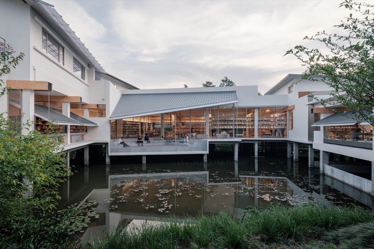 A straight-on view of the Xixi Goldmye Bookstore, which floats above a body of wetlands