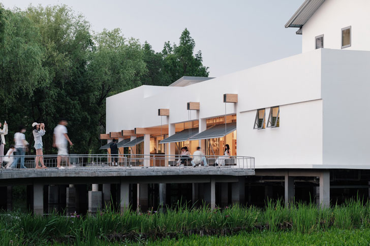 Visitors sit outside of the Xixi Goldmye Bookstore on a floating bridge