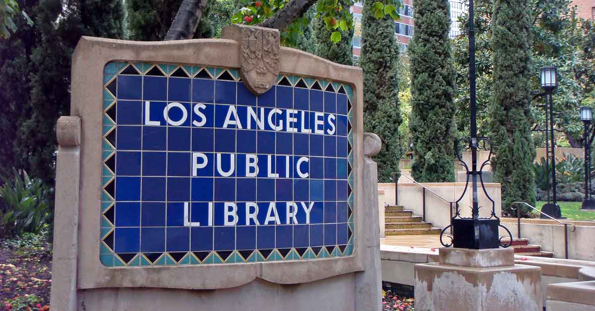 A blue tile sign with white letters reading "Los Angeles Public Library"