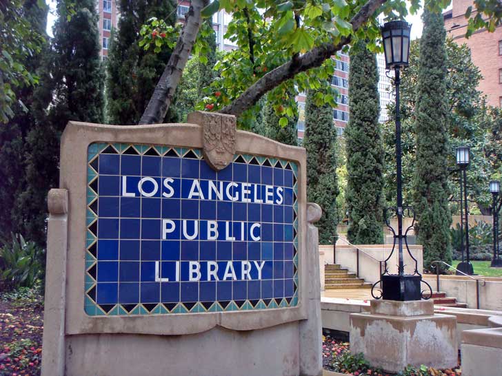 A blue tile sign with white letters reading "Los Angeles Public Library"