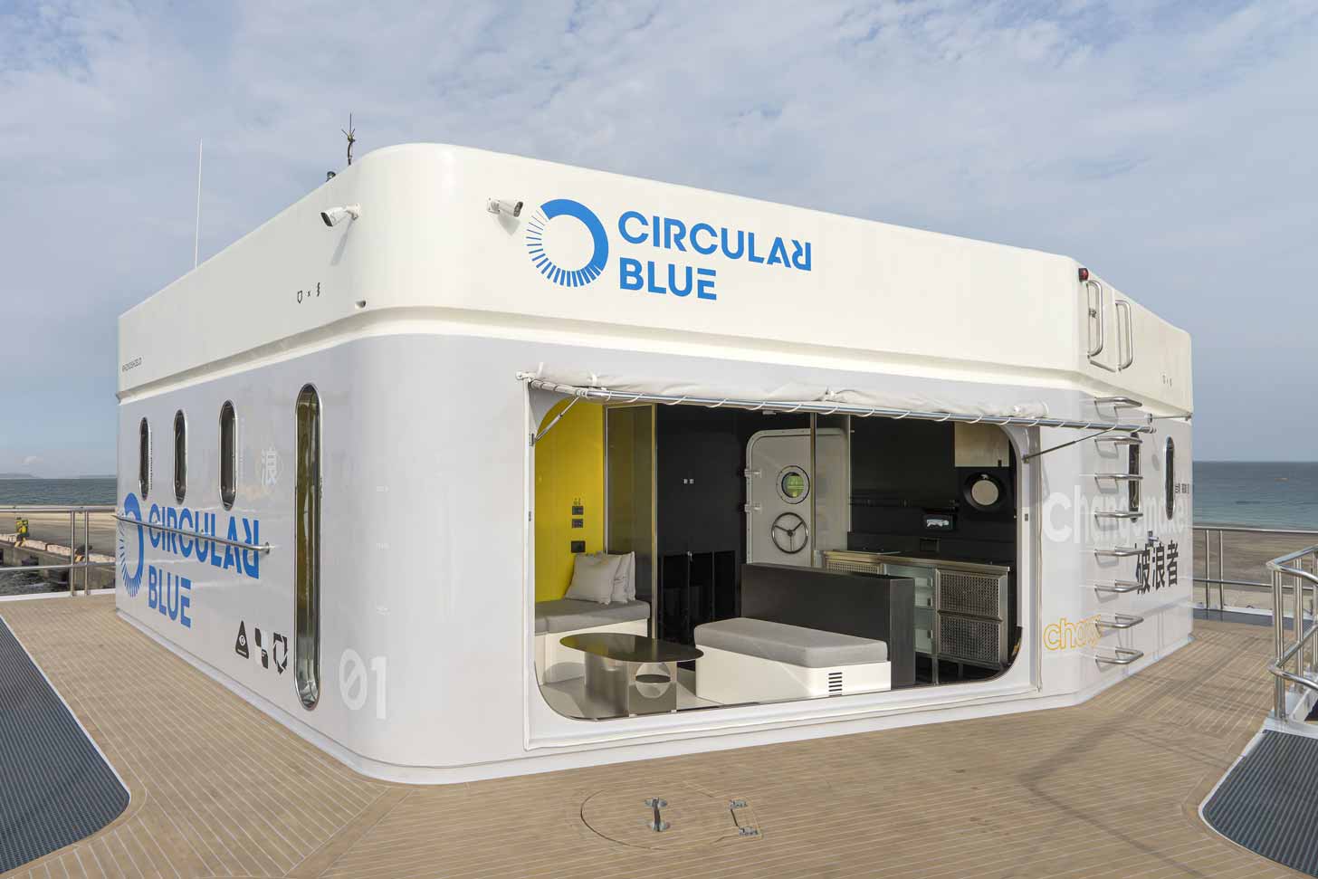 A small lab and trash collection station called CircularBlue sits outside next to the ocean