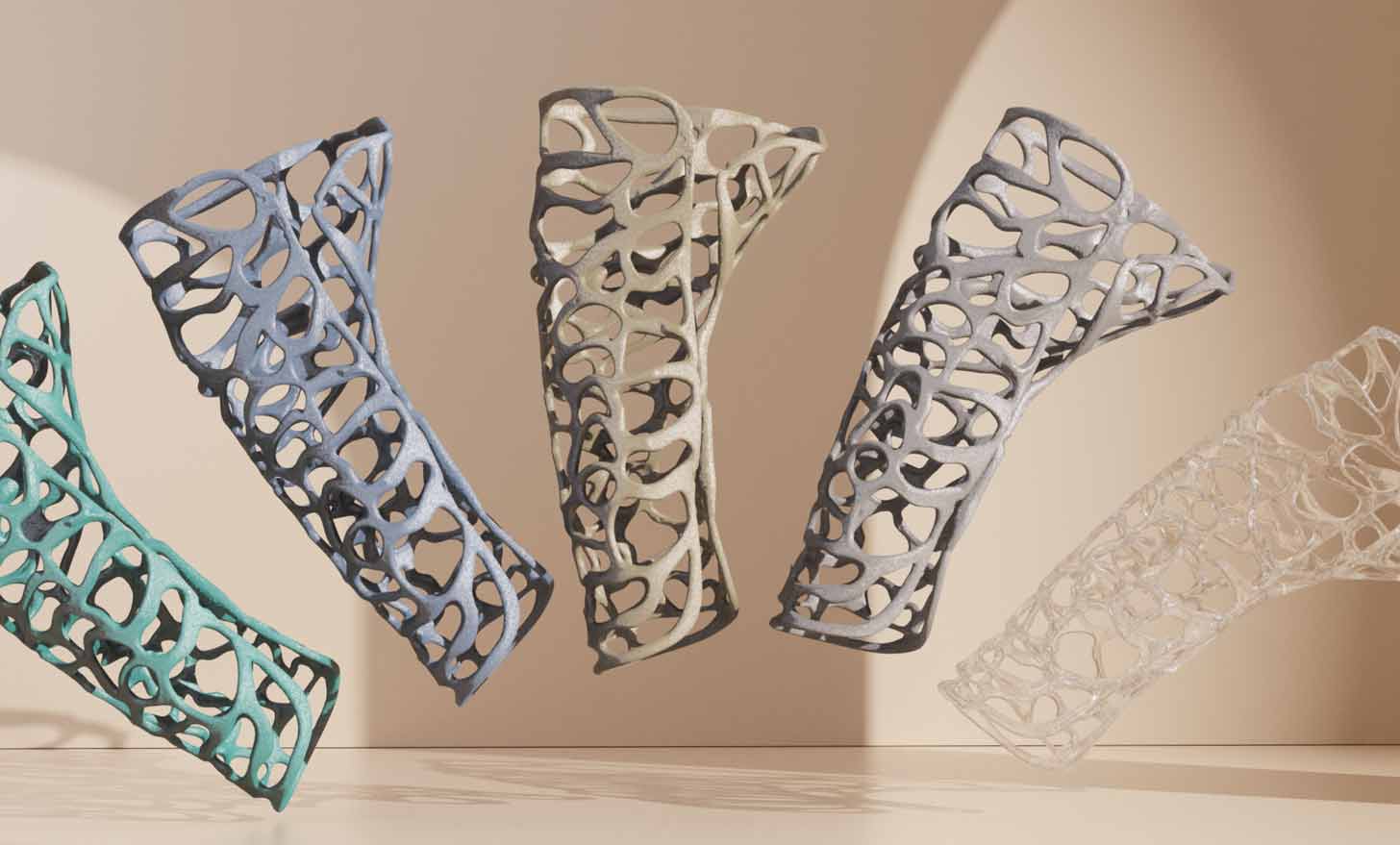 An array of bendable 3D-printed casts in blue, purple, tan, and clear colors
