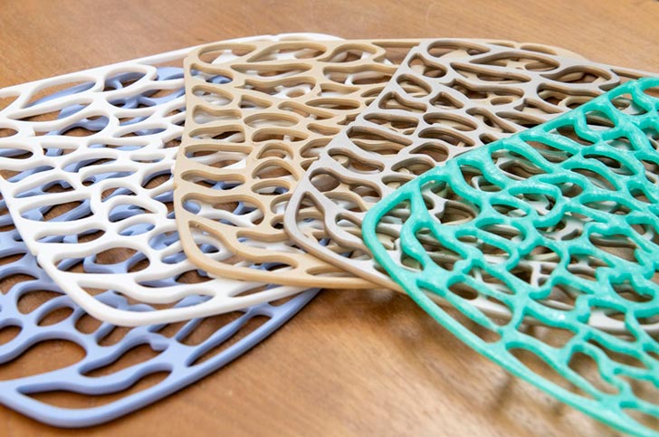 A number of flat 3D printed nylon sheets in various colors
