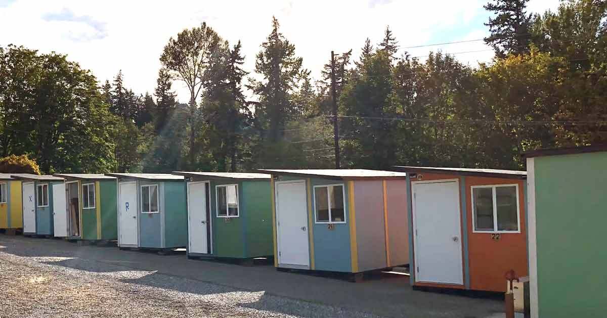 A row of multi-colored tiny homes.