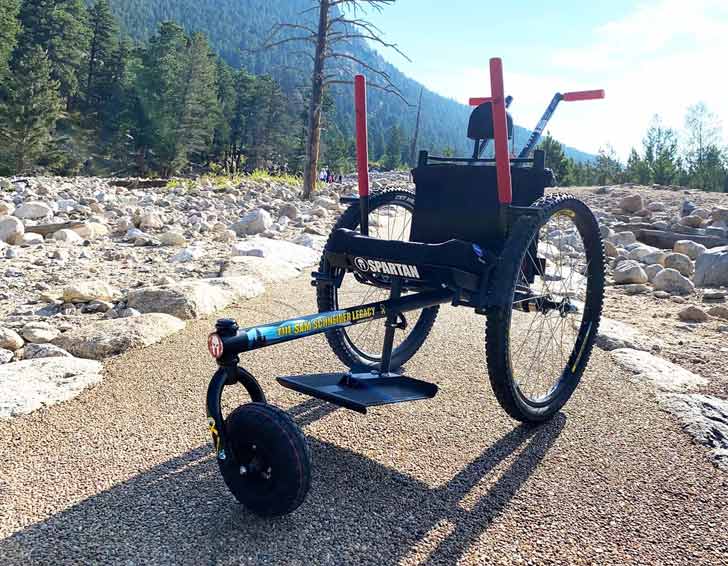 An all-terrain wheelchair sits on a trail in Rocky Mountain National Park