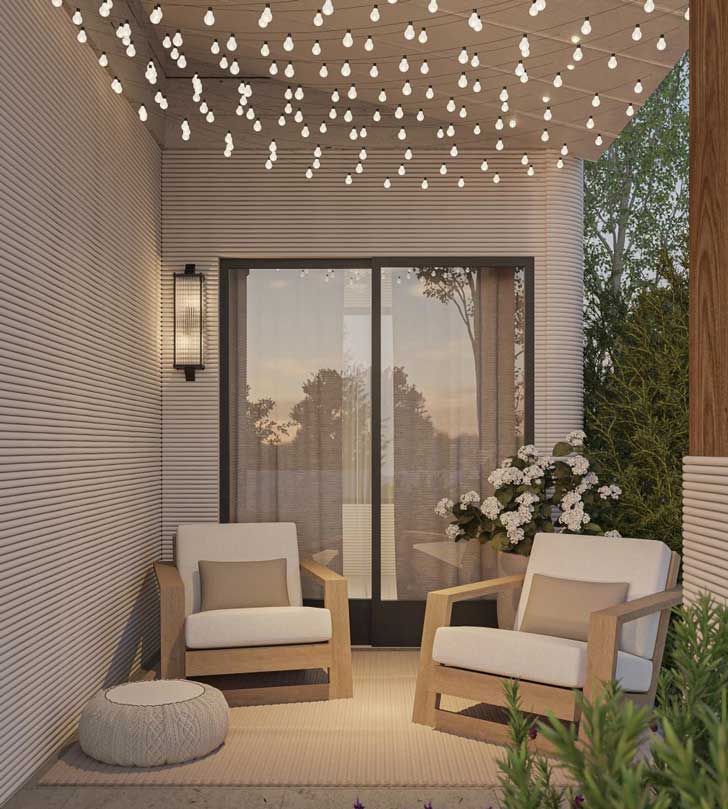 A covered patio with round string lights and two outdoor chairs