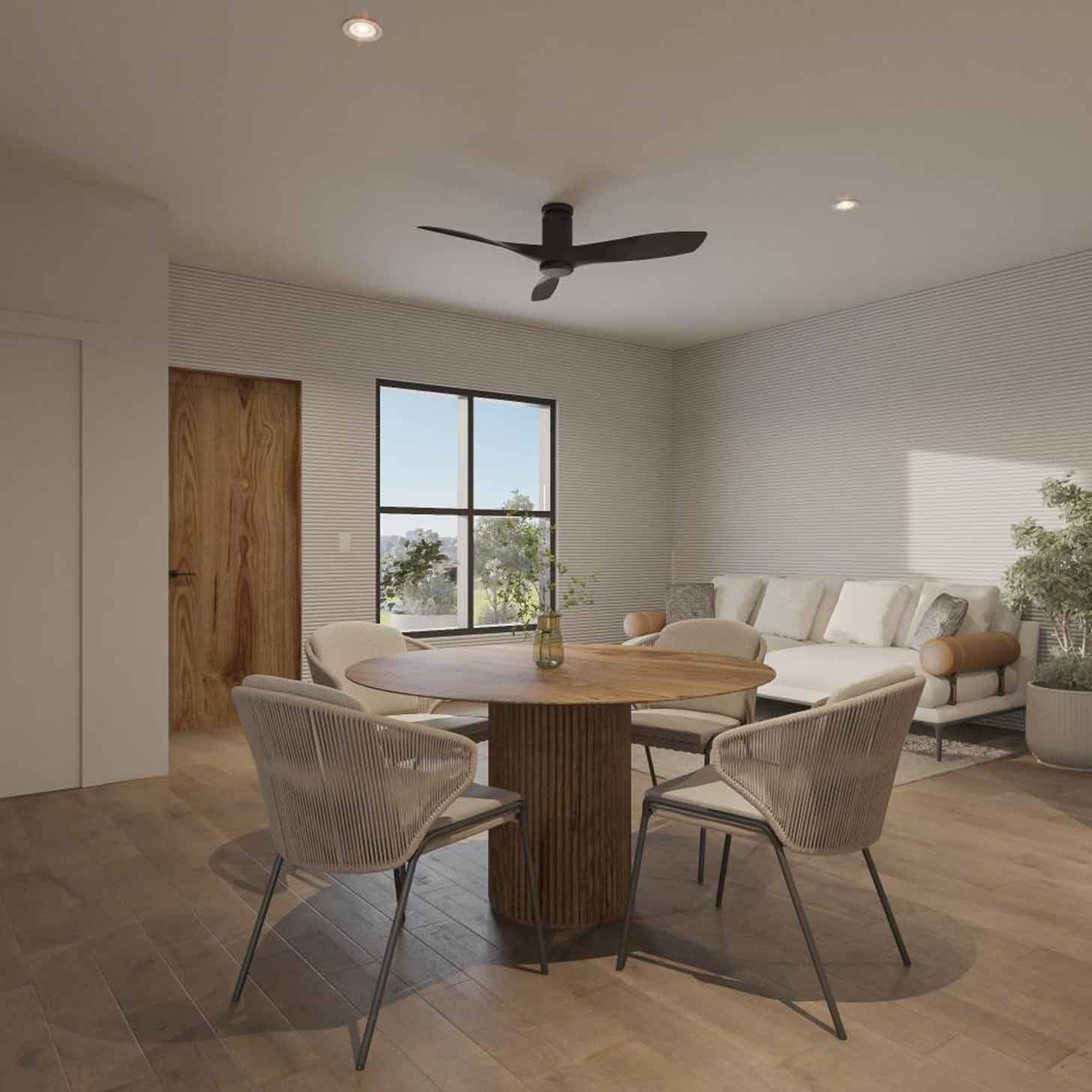 A kitchen and living room have clean, beige furniture inside of a 3D-printed home