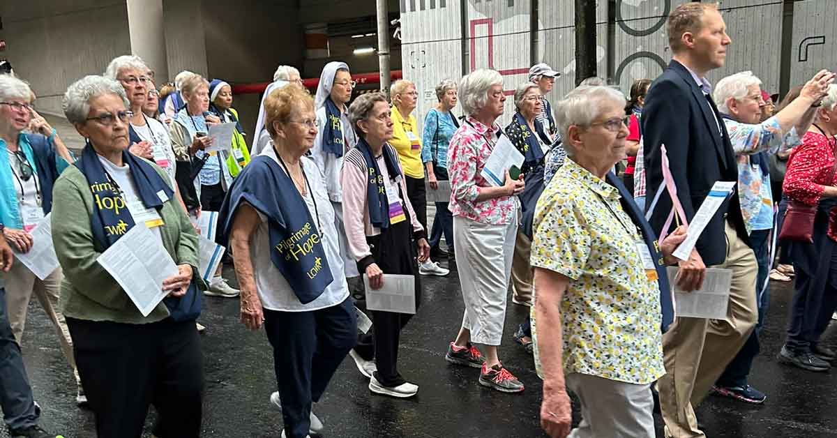 A group of older Catholic sisters walk through the streets of downtown Atlanta