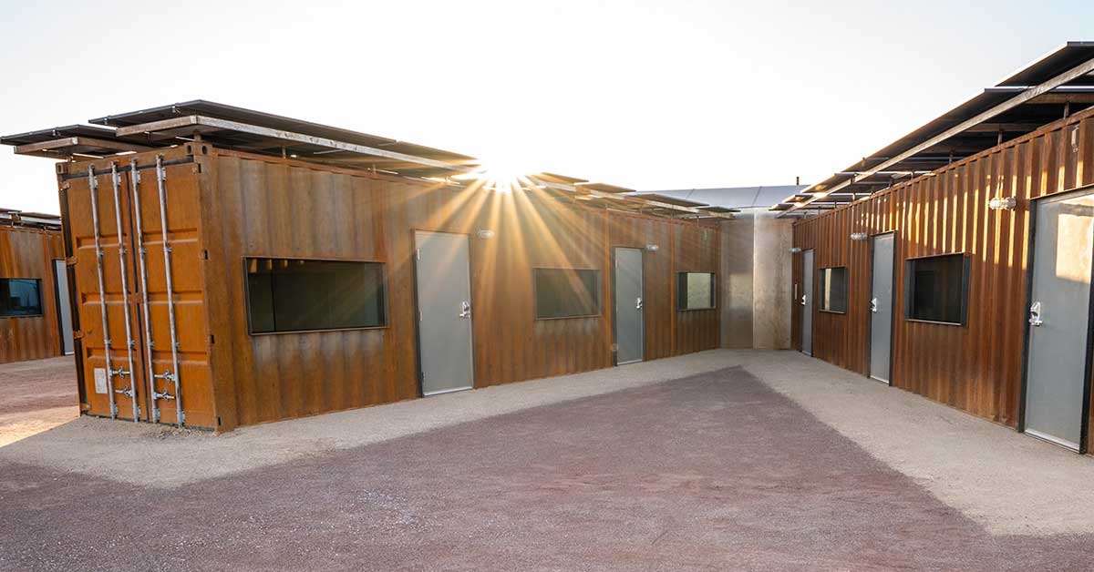 An orange steel shipping container home in Phoenix, Arizona in the sun