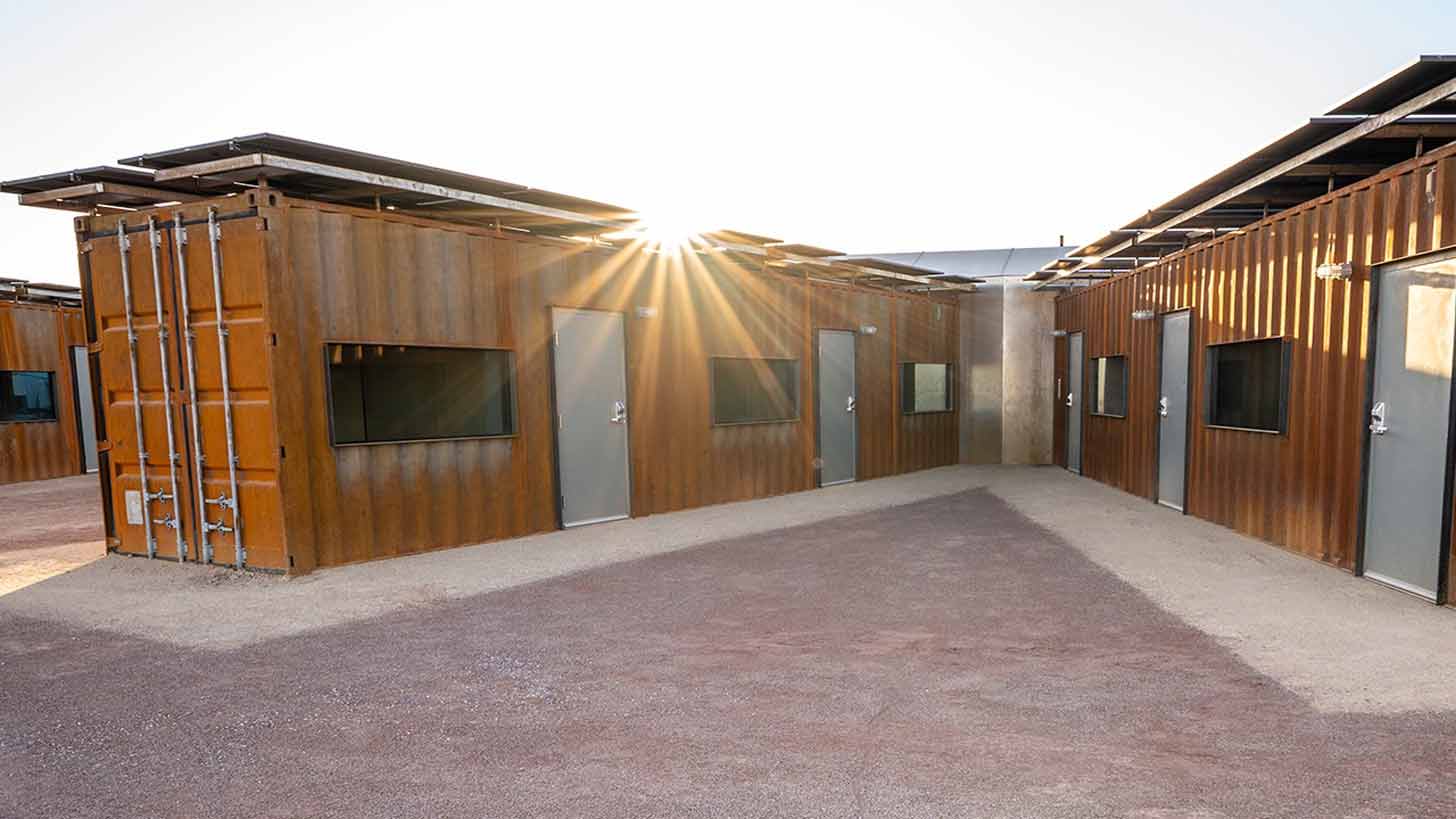 An orange steel shipping container home in Phoenix, Arizona in the sun