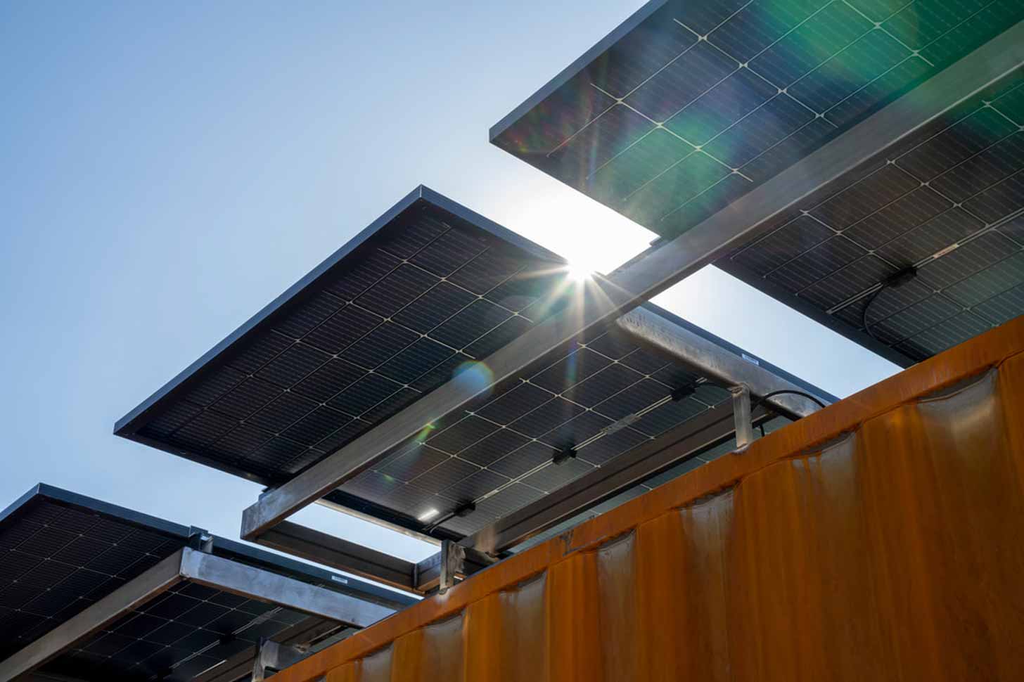 A close-up of a solar panel on the roof of a shipping container