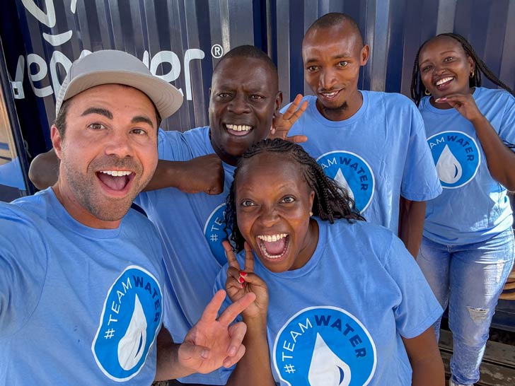 Mark Rober takes a selfie with four WaterAid team members at Dyeste Village