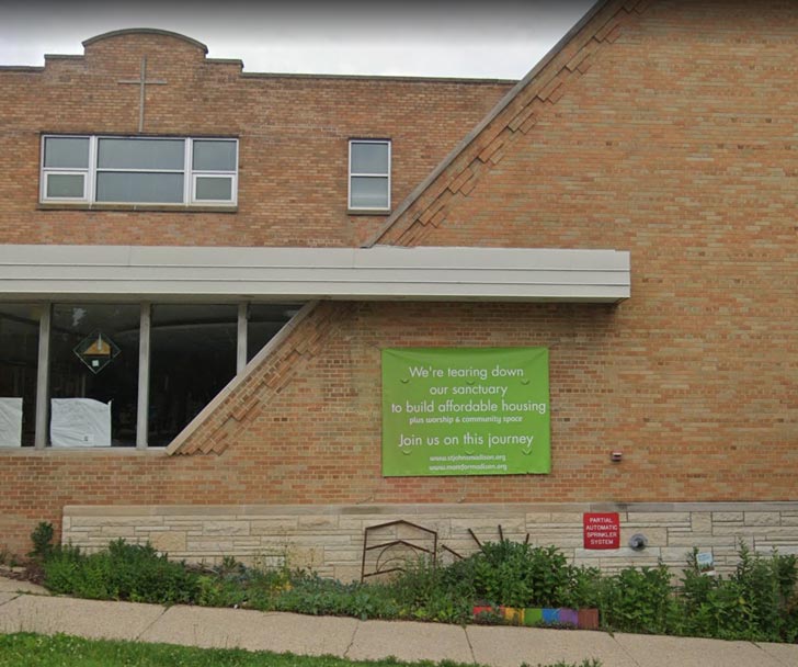 A green banner on the side of a brick church reads: "We're tearing down our sanctuary to build affordable housing. Join us on this journey."
