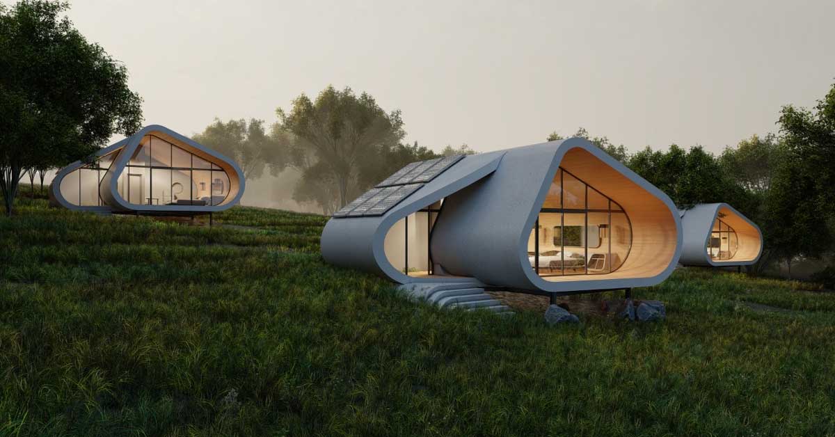 Three pod-like homes sit atop rolling hills of grass