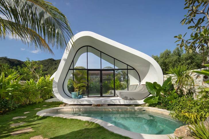 A white pod-shaped home sits beside a pool in Indonesia