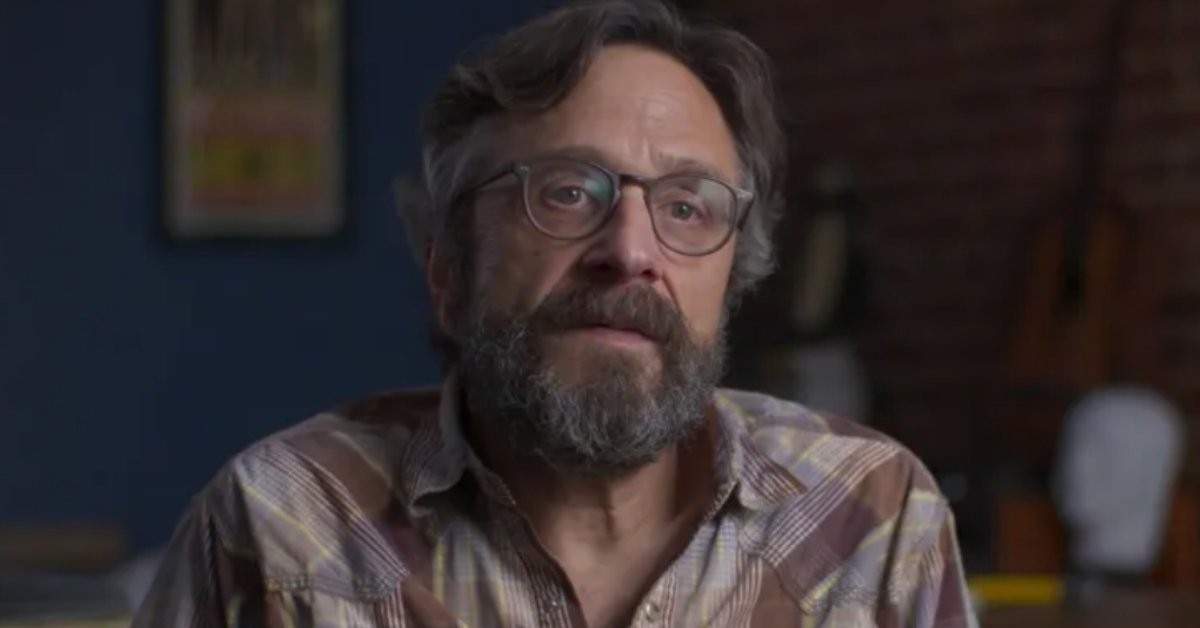 Marc Maron, a white male in his 60s with a beard, mustache, and glasses is mid-sentence in a frame from the documentary "Anxiety Club."