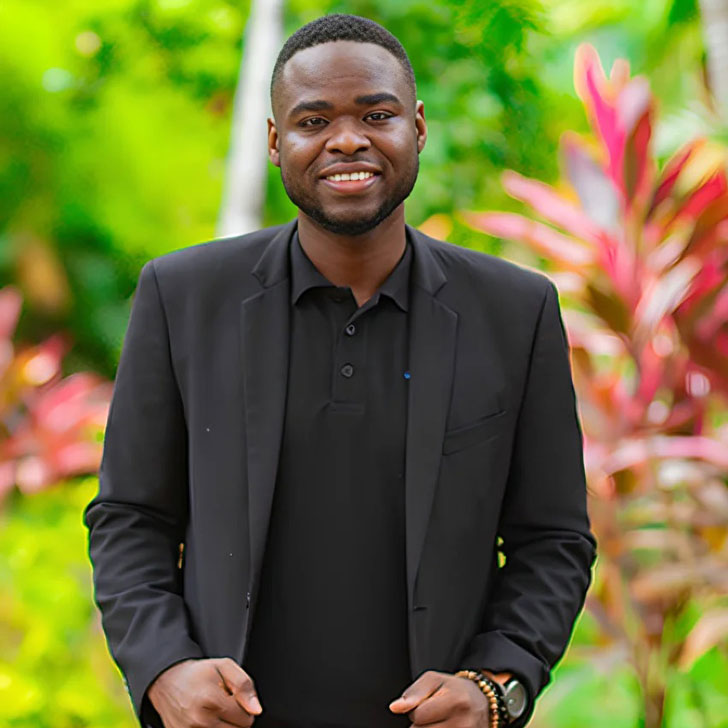 A Jamaican man in a black suit.