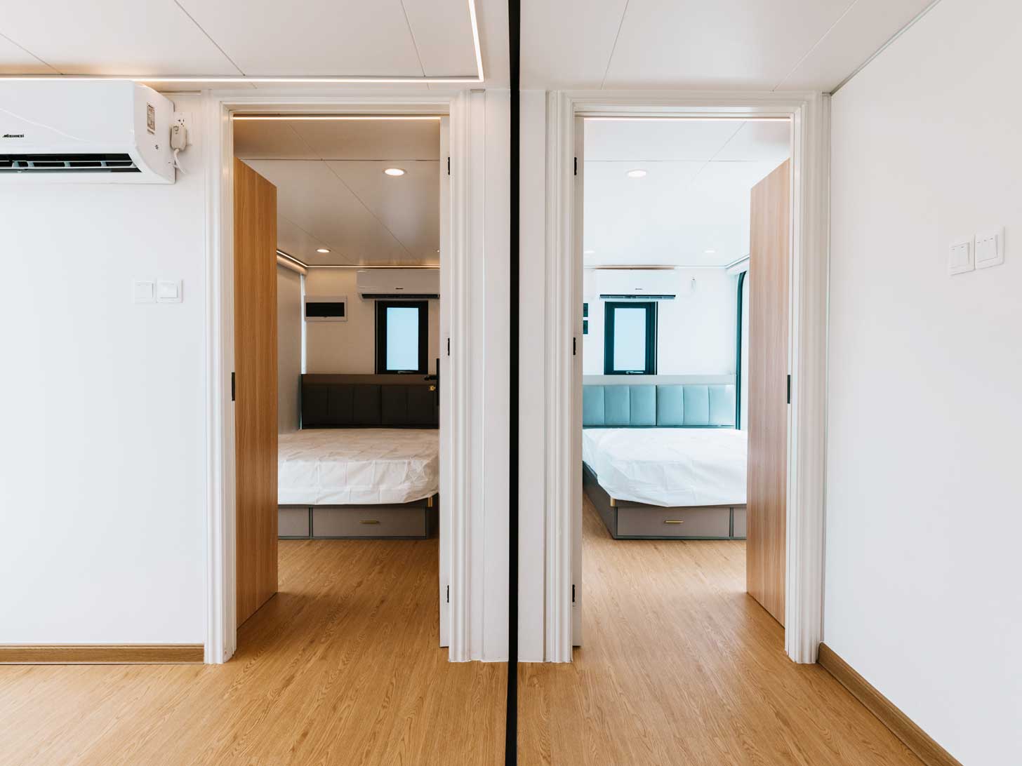 Two bedrooms sit side-by-side in an interior view of a tiny home