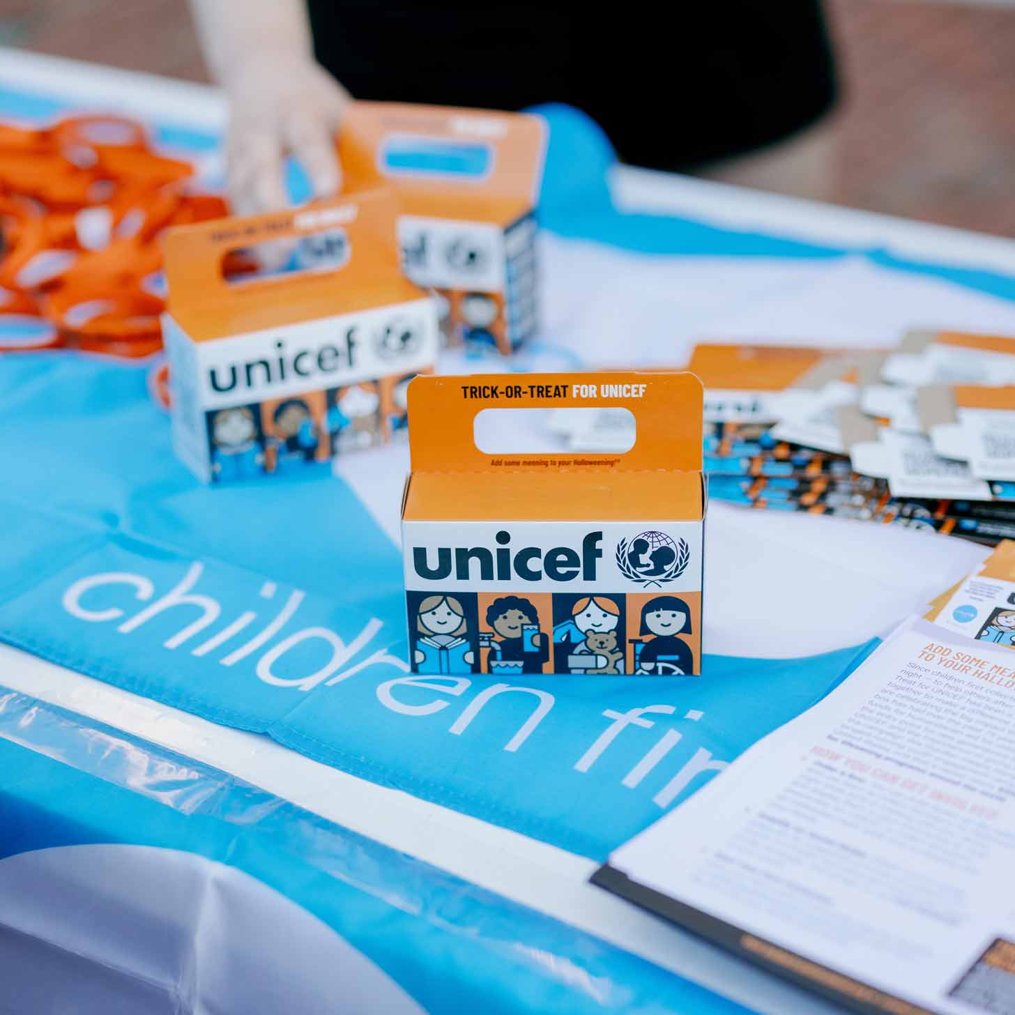 An orange cardboard box with UNICEF's logo sits on a table