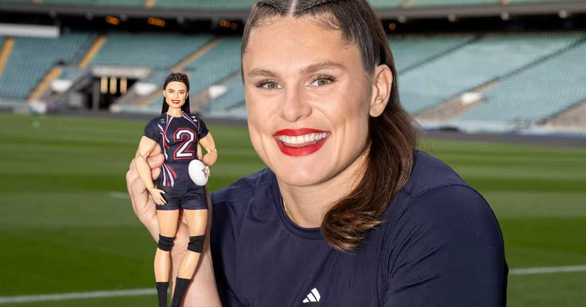 Rugby player Ilona Maher holds up a Barbie doll version of herself, smiling