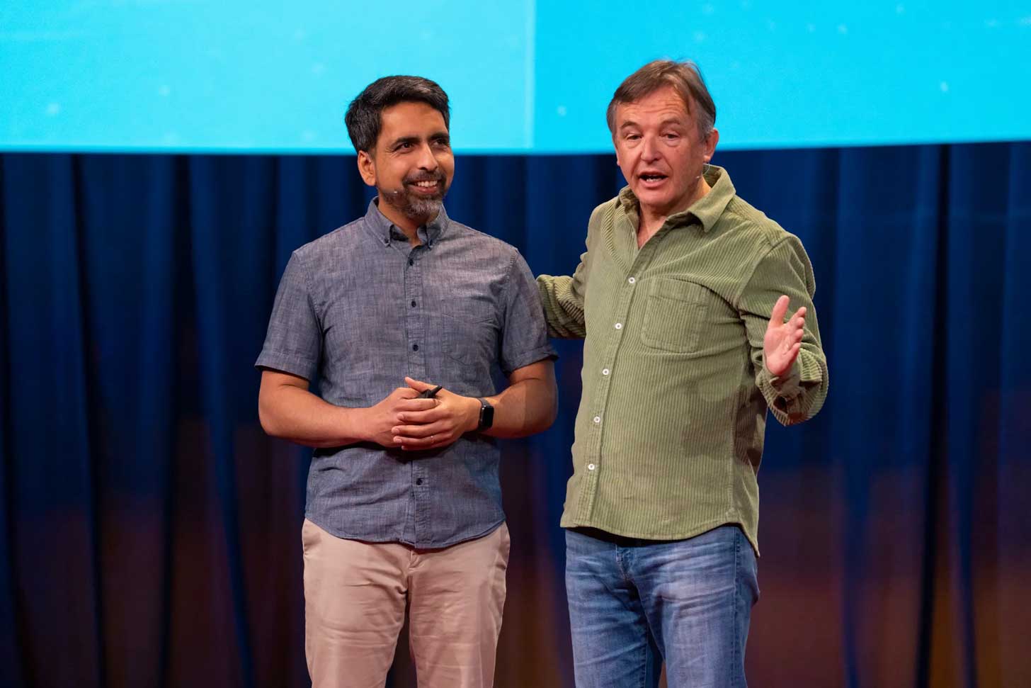 Sal Khan stands next to Chris Anderson on the TED stage