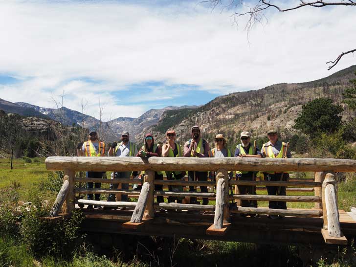 A group of volunteers smiles in Rocky Mountain National Park