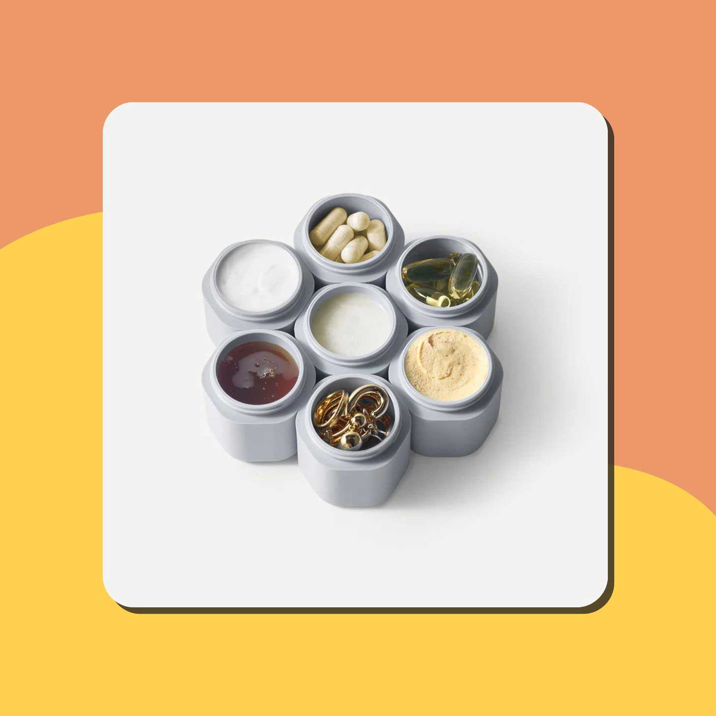 Six gray travel capsules filled with pills and lotions