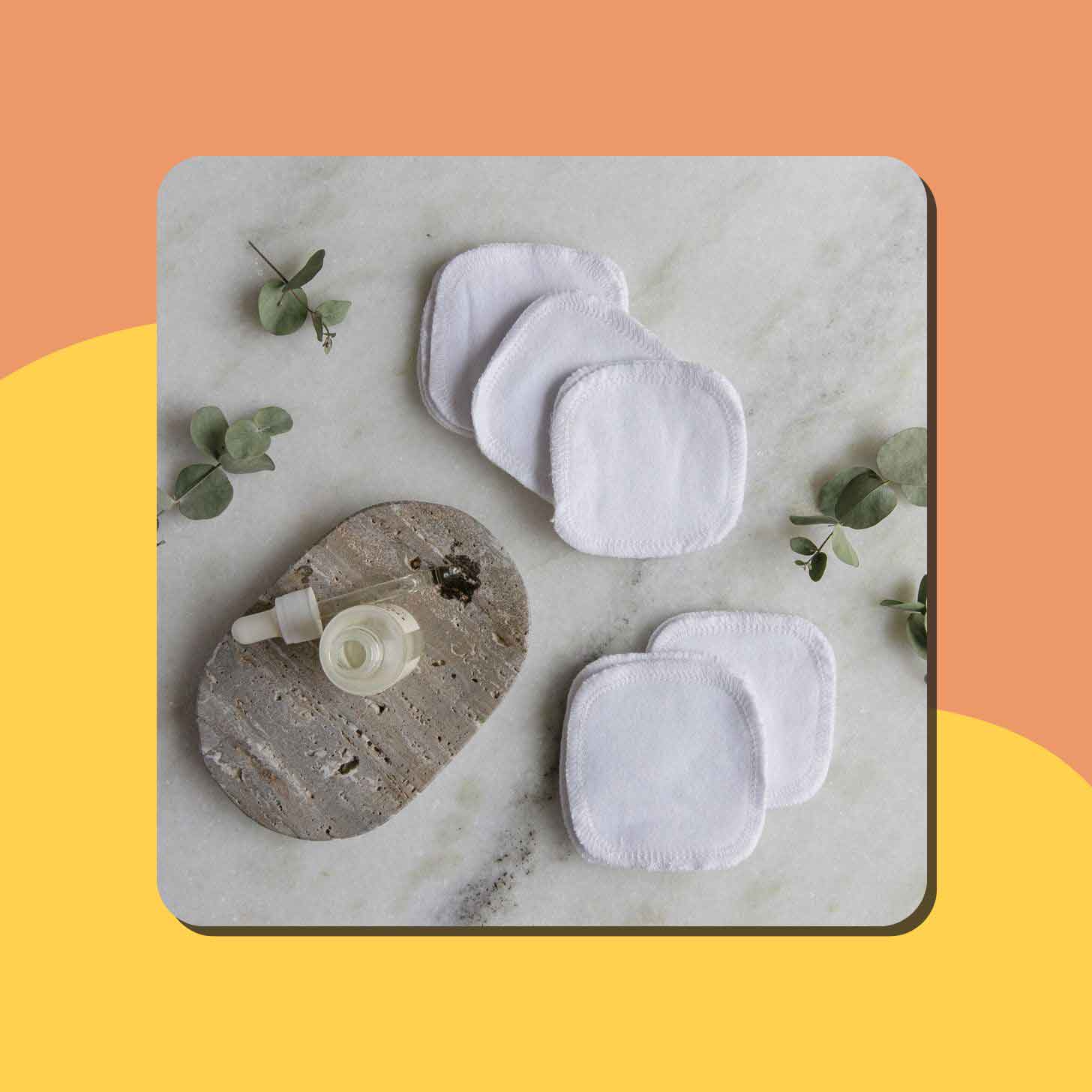 White cotton facial rounds sit on a granite countertop
