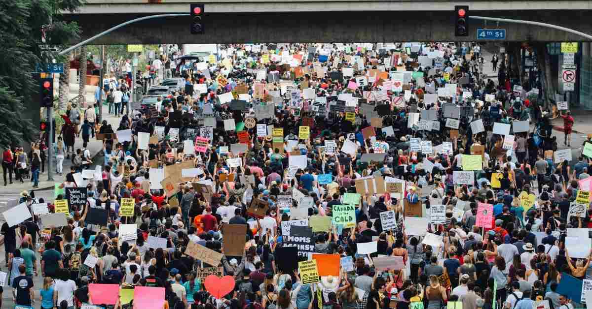 A crowd of protestors holding up signages