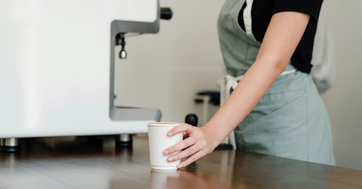 A barista serves up a cup of coffee
