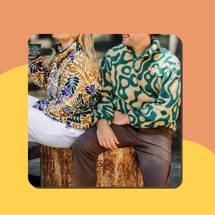 A woman and a man wear colorful fleece jackets from Parks Project