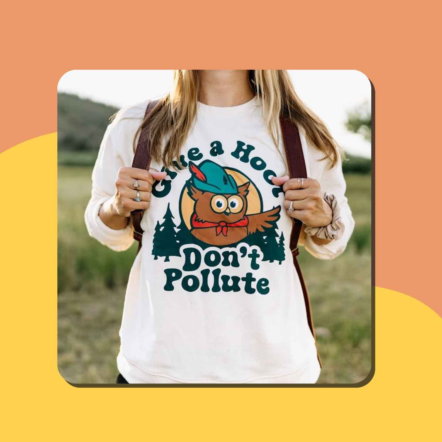 A woman wears a white t-shirt with an owl on it. It reads "give a hoot, don't pollute"