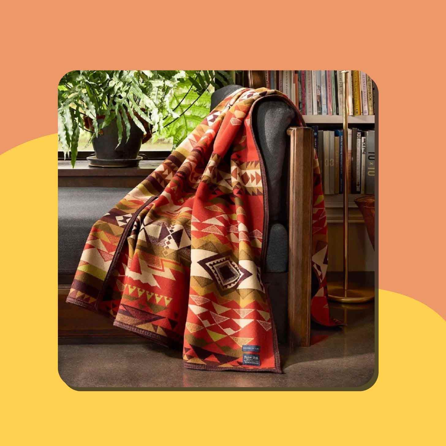 A Pendleton throw blanket on the arm of a couch