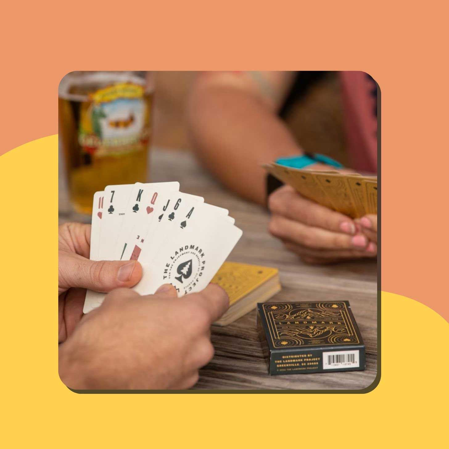 Someone holds up a hand of playing cards