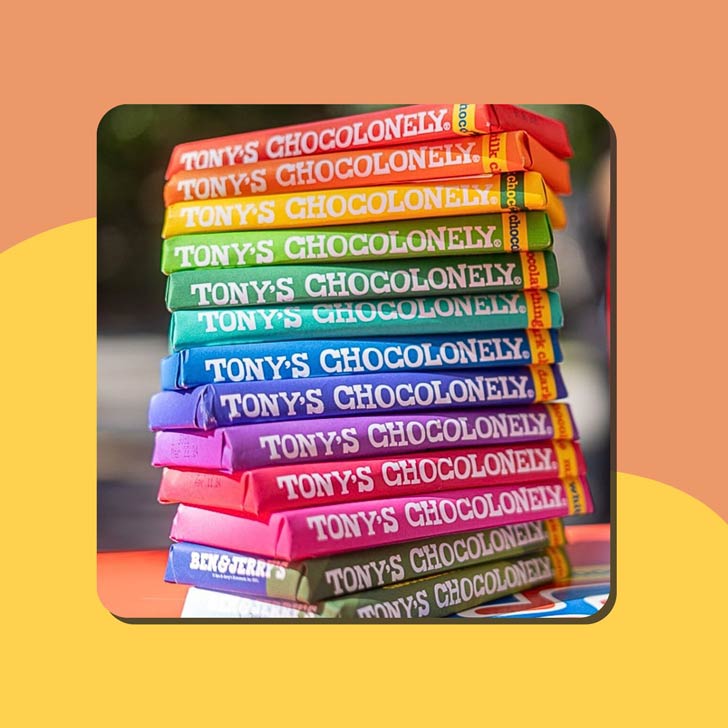 A stack of chocolate bars from Tony's Chocolonely in a rainbow of colors