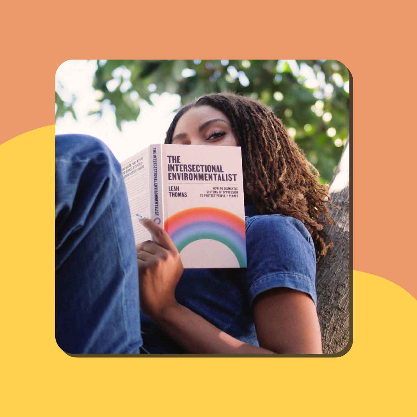 Leah Thomas reads her book "The Intersectional Environmentalist" in a tree