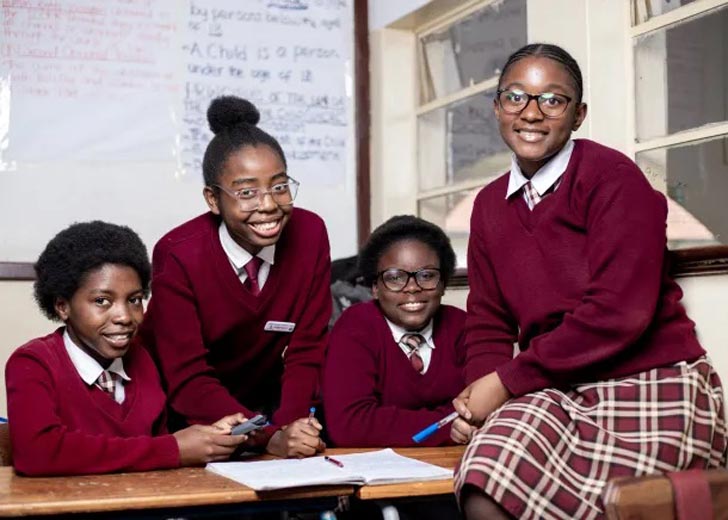 Four female students in a classroom in Africa